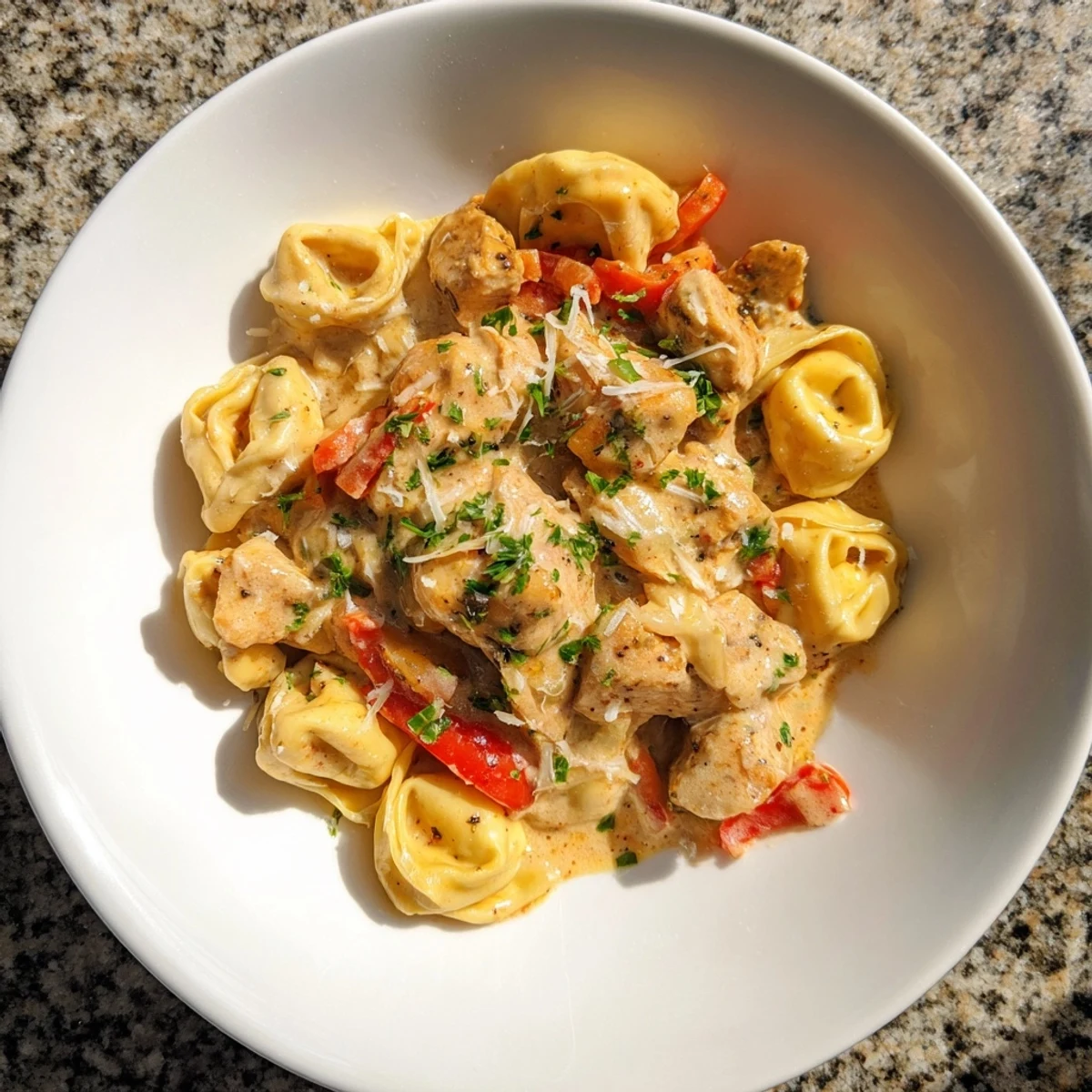 Creamy Zesty Cajun Garlic Parmesan Chicken Tortellini topped with fresh parsley, a delicious and easy weeknight dinner.