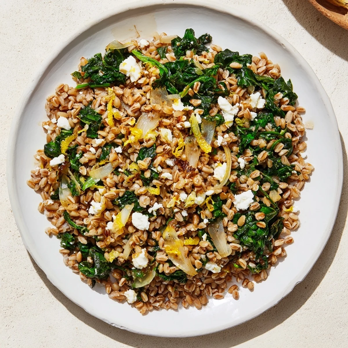Warm Farro & Greens Pilaf with Toasted Almonds: a comforting bowl of nutty farro and vibrant greens, perfect for lunch.
