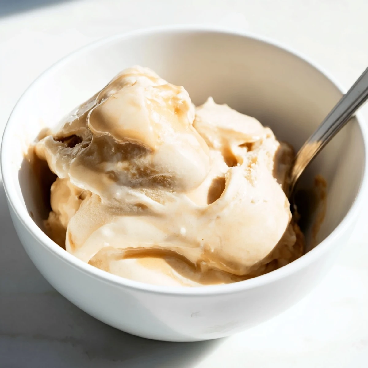 Homemade Peanut Butter Banana Ice Cream, perfectly blended with hints of vanilla, served in a dish.