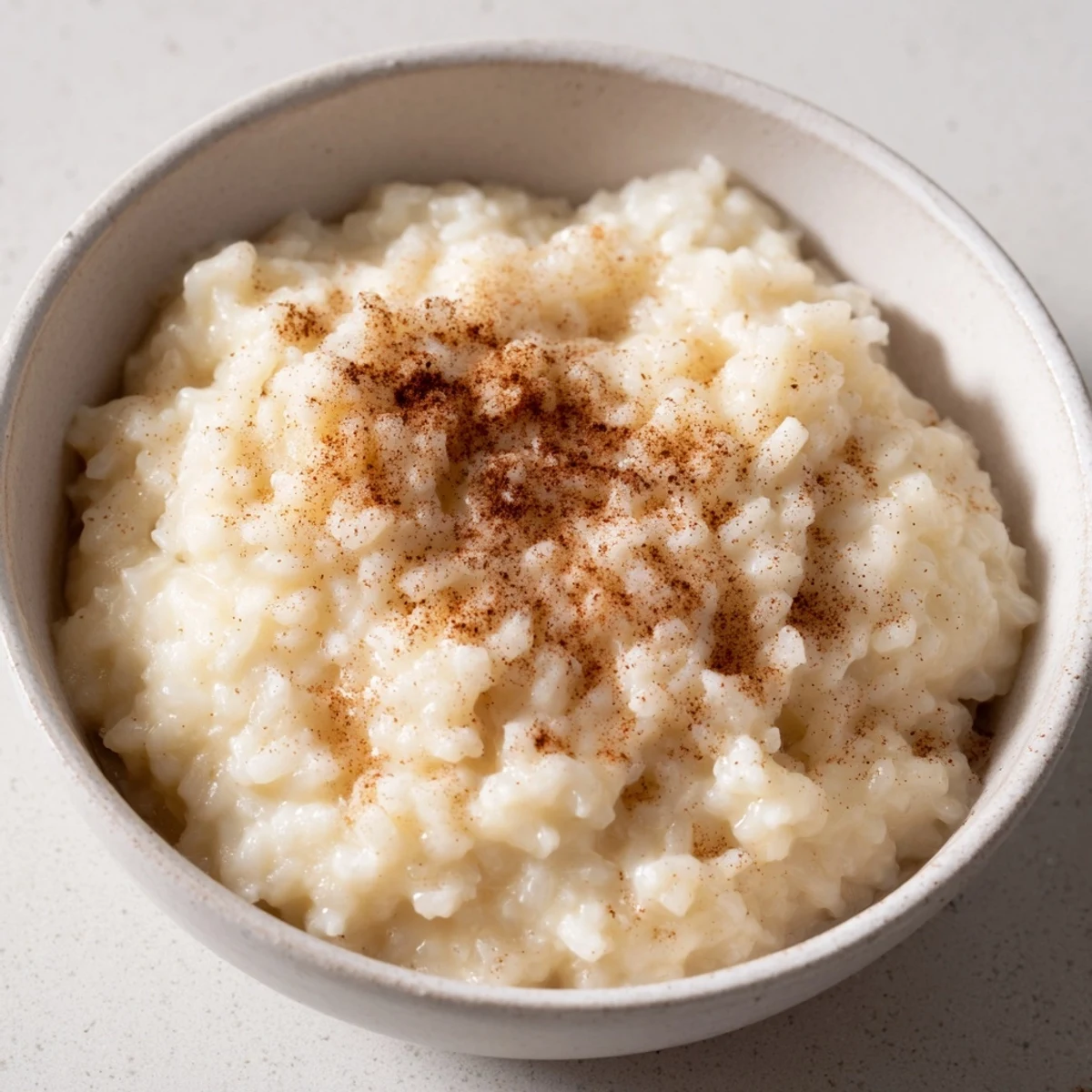 Smooth Rice Pudding with Leftover Rice, served in a bowl, with a rich, inviting texture and scent.