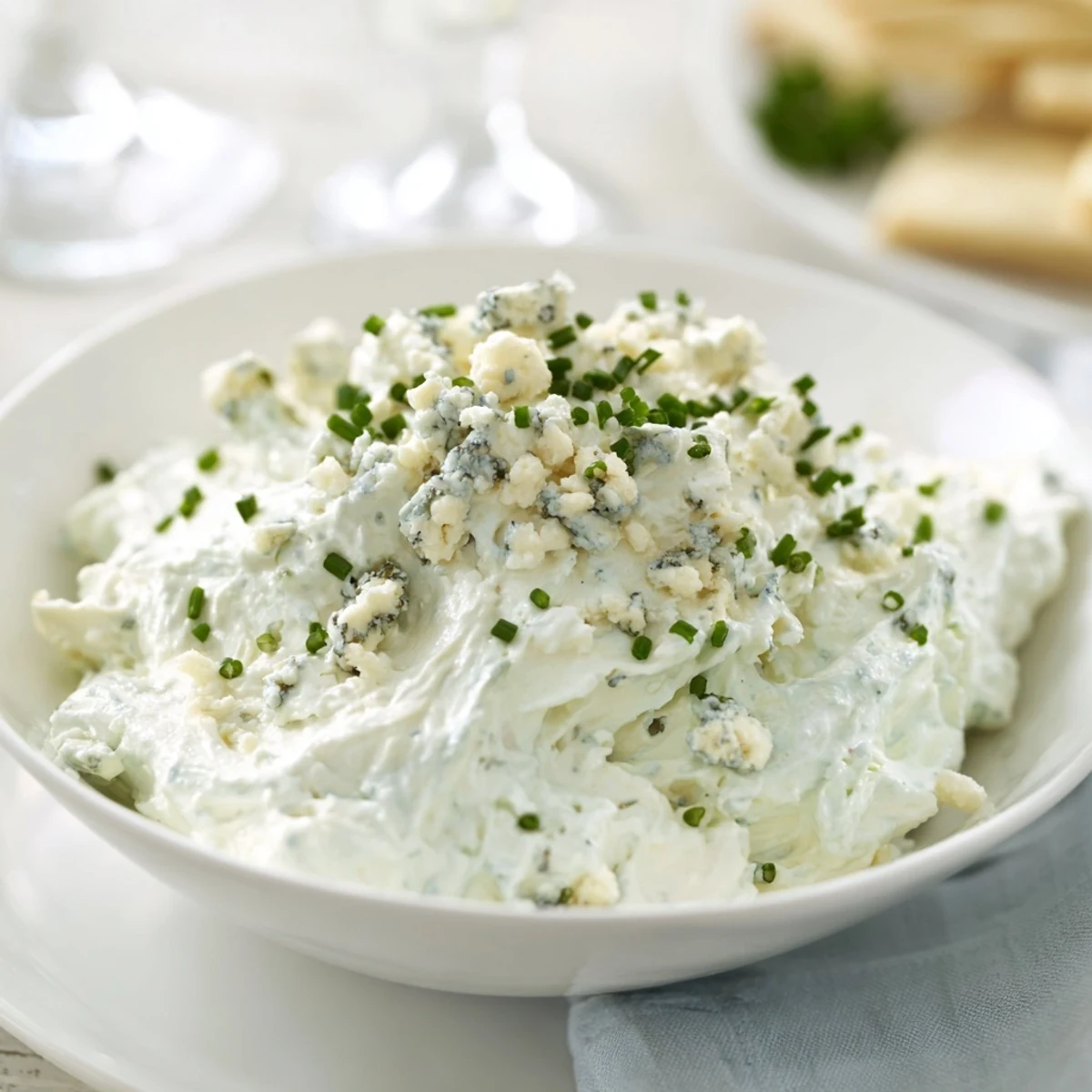 A beautiful, icy blue Frozen Pond dip, surrounded by crunchy chips and fresh, colorful veggie dippers.