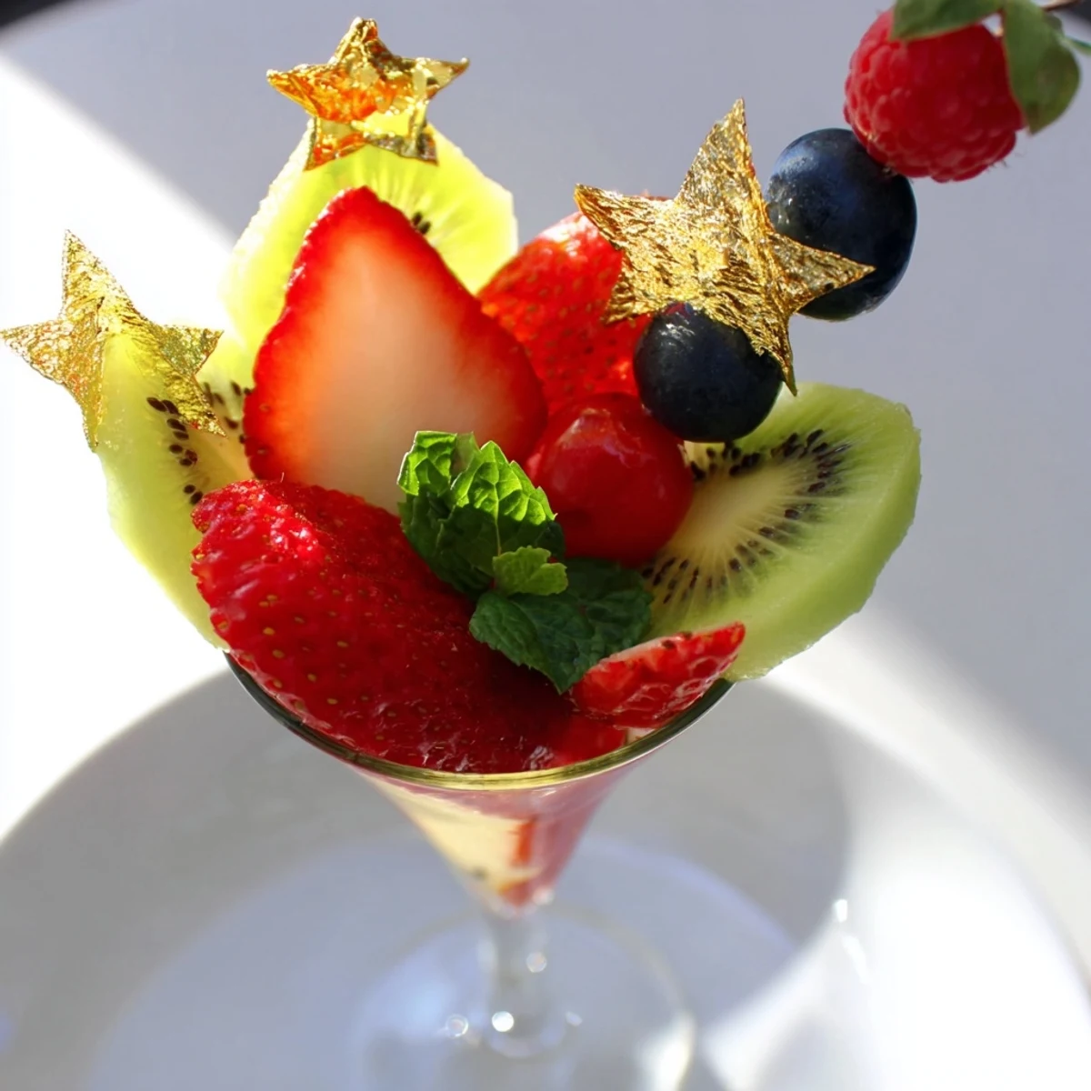 Elegant champagne flute fruit garnishes featuring fresh strawberries, kiwi, and pineapple ready to serve.