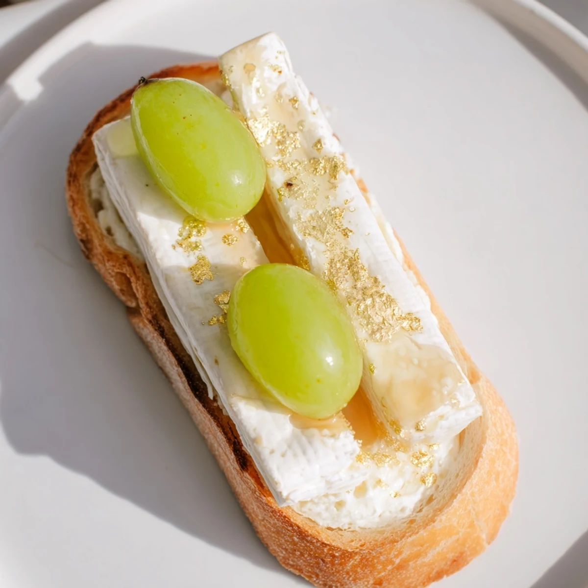 Golden edible shimmer dusts the sparkling Champagne toasts, ready for a special celebration.