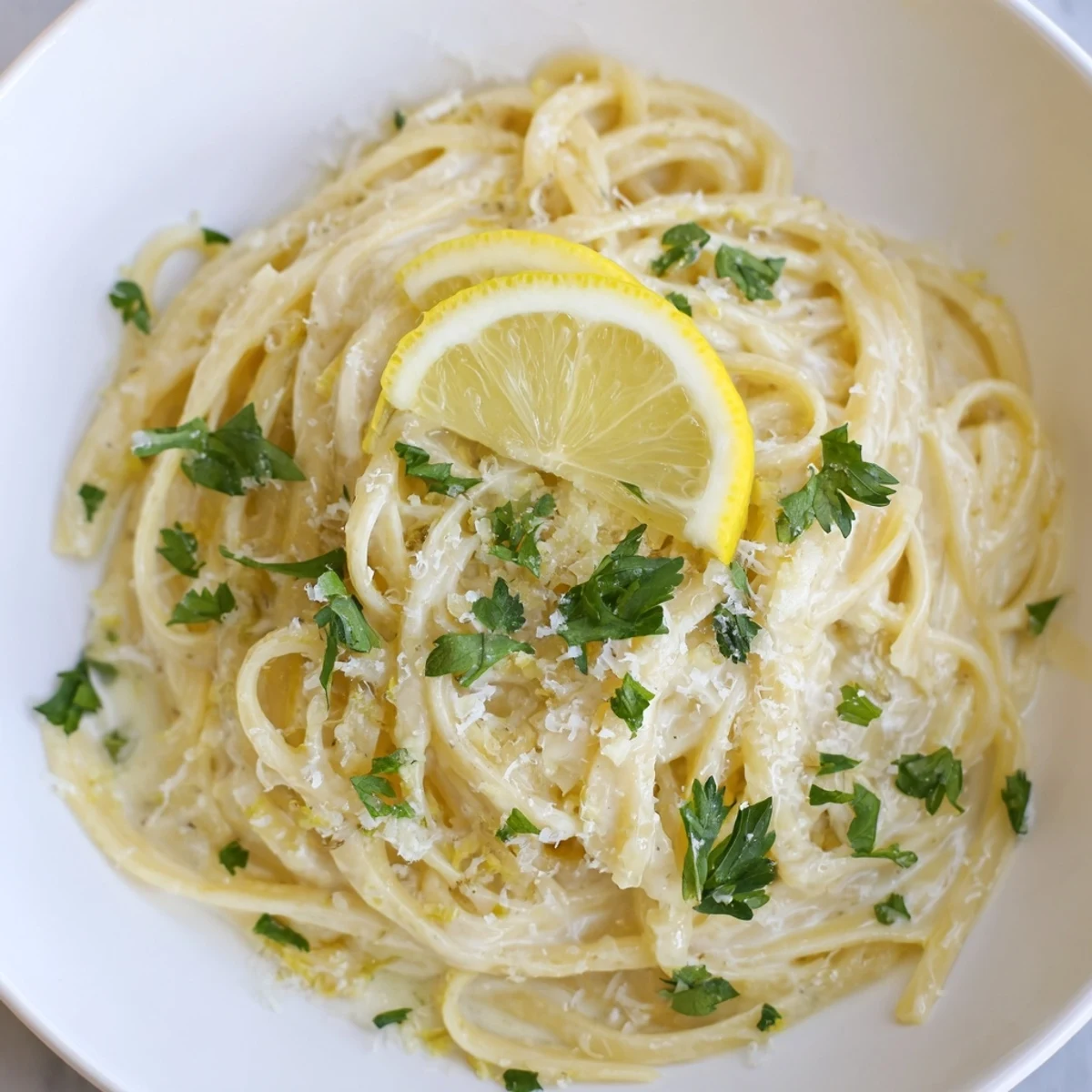 Freshly made Lemon-Garlic Greek Yogurt Pasta with grated Parmesan, ideal for a weeknight meal.