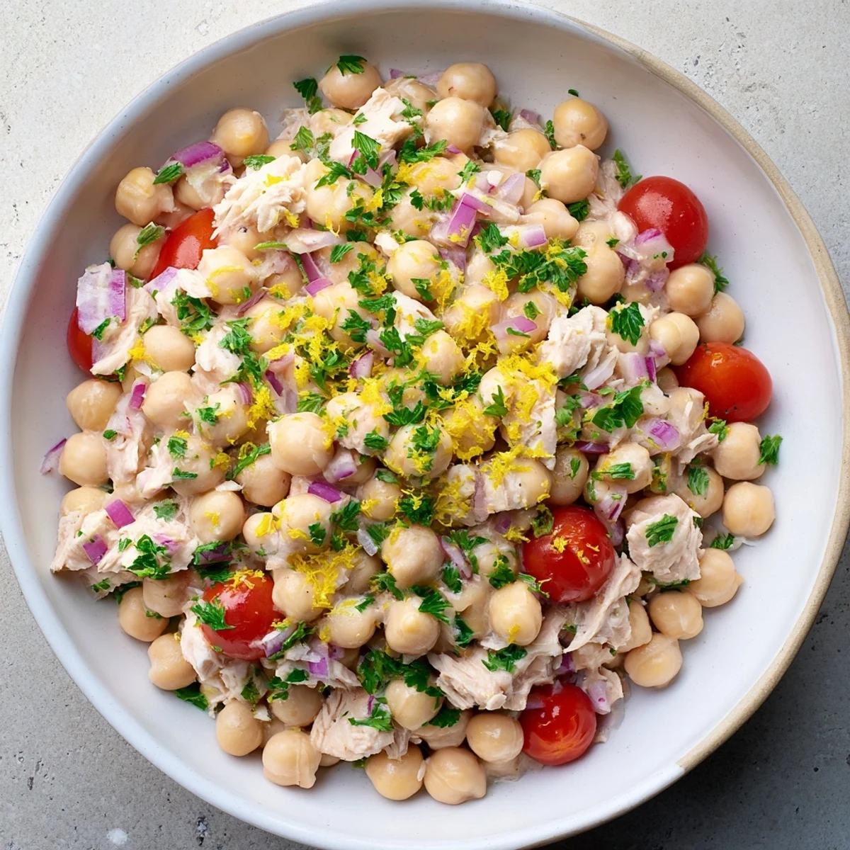 A close-up of a vibrant bowl of Dense Chickpea and Tuna Salad, ready to be enjoyed.