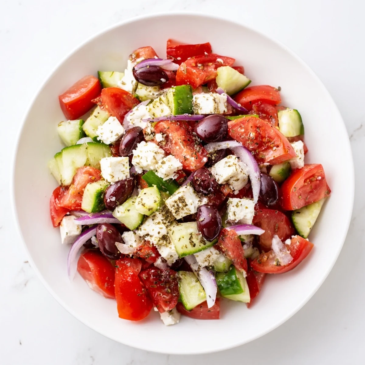 Vibrant Mediterranean Salad, showcasing juicy tomatoes, feta, and olives, ready to be tossed with dressing.