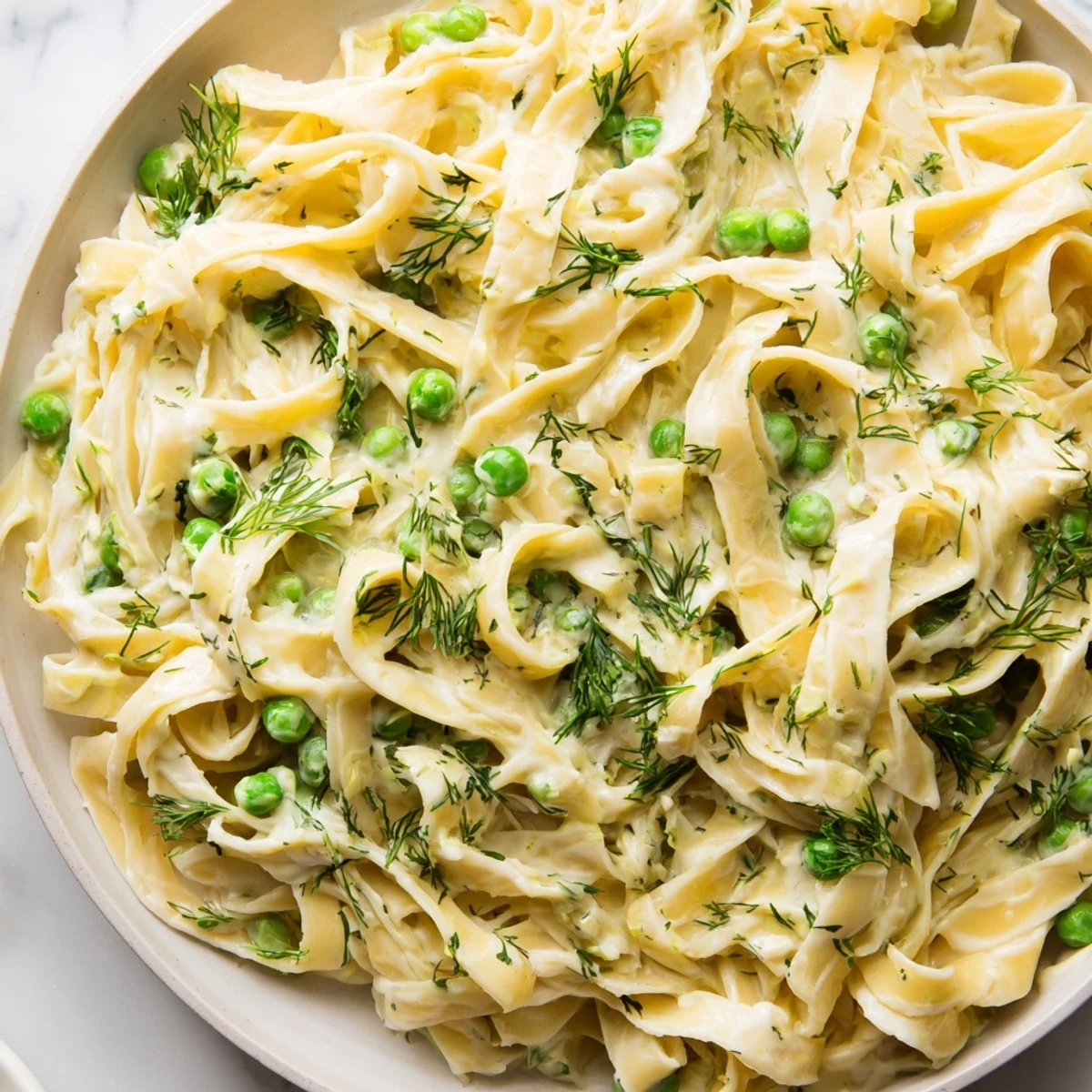 Close-up of a bowl of Creamy Dill Pasta, a vegetarian delight with a rich, savory aroma.