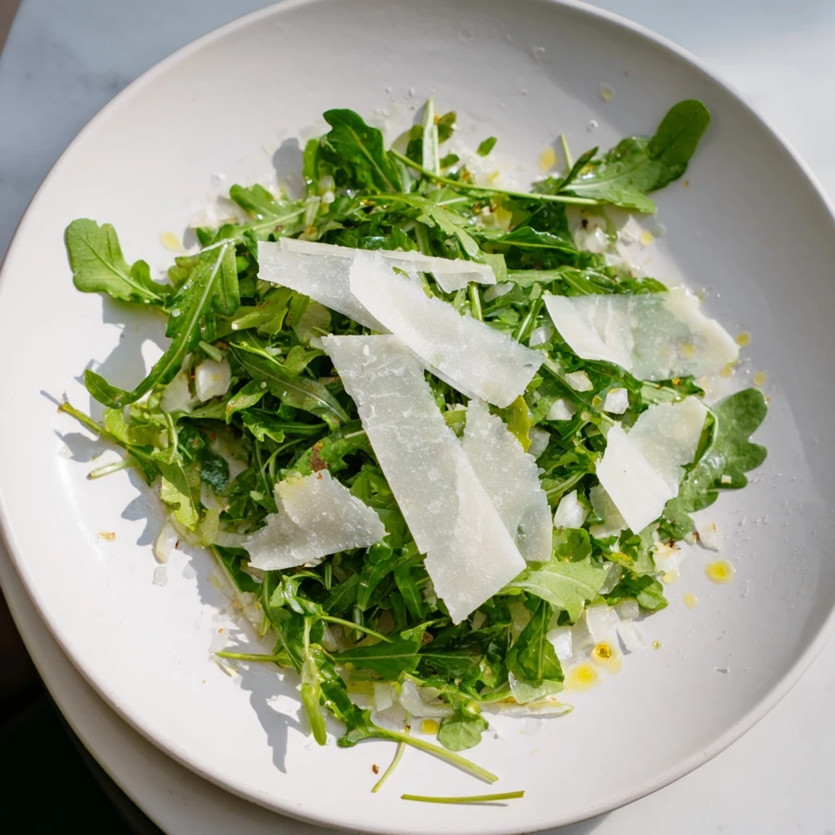 Vibrant arugula salad with lemon dressing, ready to enjoy with a burst of peppery flavor.