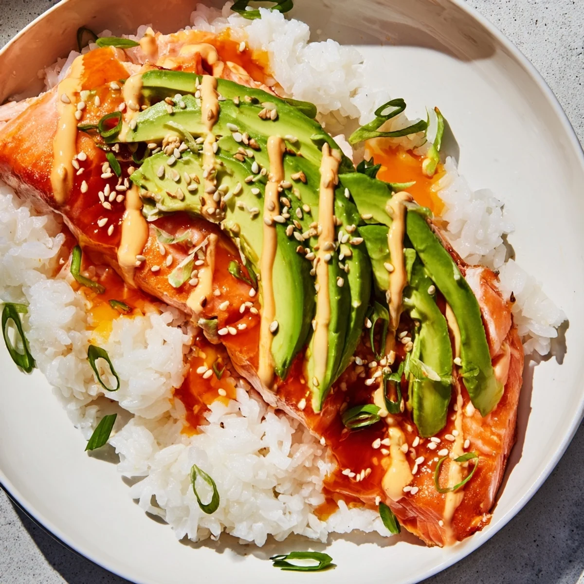 Enjoy a comforting bowl of Classic Salmon Rice, complete with sesame seeds and seaweed for wrapping.