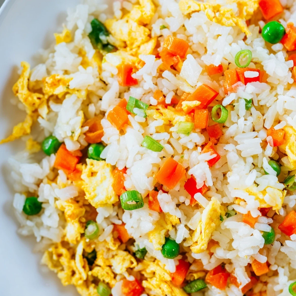 Steaming bowl of homemade Egg Fried Rice with tender vegetables, ready to enjoy for a quick vegetarian dinner any night of the week.