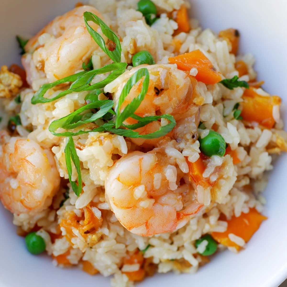Sizzling shrimp garlic fried rice topped with fresh green onions and lime wedges, perfect for a flavorful Asian fusion lunch.
