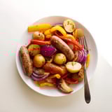 Golden potatoes and colorful bell peppers combine in this easy Sheet-Pan Sausage recipe, ready to serve.