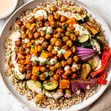 The finished Roasted Chickpea Buddha Bowl shows fluffy rice topped with flavorful roasted chickpeas and vibrant veggies.
