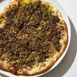 A close-up of freshly baked Levantine Zaatar Bread, with sesame seeds and olive oil glistening.
