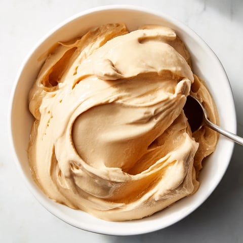 Smooth Peanut Butter Banana Ice Cream swirled into a bowl, ready to enjoy this healthy dessert.