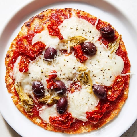 Golden-brown tortilla pizza loaded with bubbly cheese and savory pantry toppings, ready to enjoy.