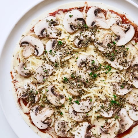 Golden, bubbly upgraded frozen pizza featuring mushrooms, extra cheese, and herbs, ready to serve.