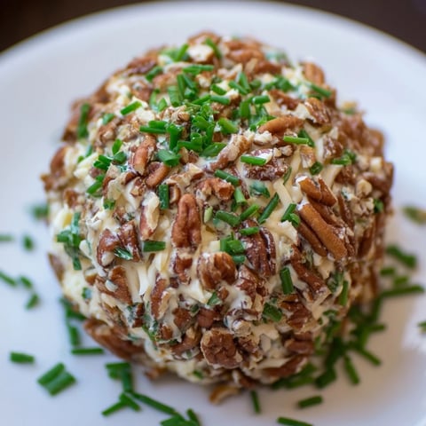 A perfectly formed Classic Cheese Ball with Ranch Seasoning, coated in crunchy pecans, ready to serve.