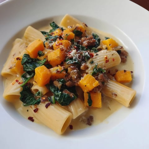 Creamy Rigatoni with butternut squash, Italian sausage, and a rich, parmesan sauce ready to savor.
