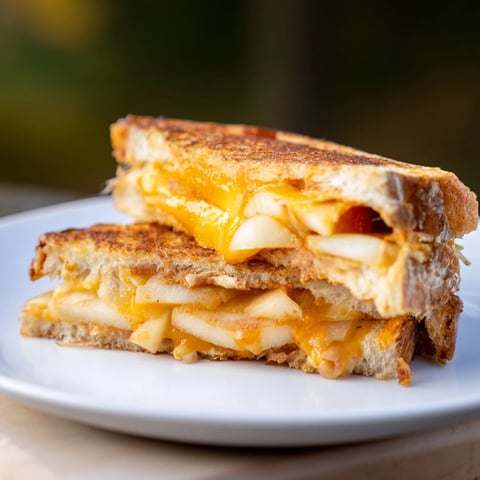 Golden-brown Caramelized Onion, Apple & Cheddar Grilled Cheese, perfectly melted and ready to enjoy.