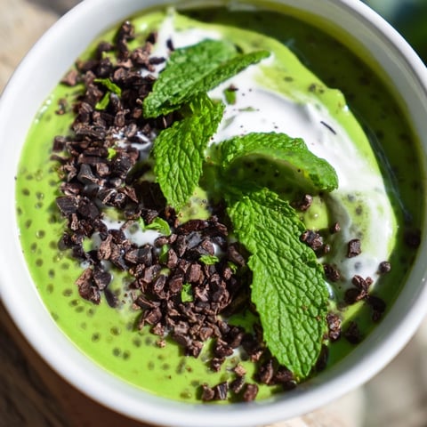Close-up of Grinch Green Mint Matcha Chia Pudding, a vibrant and refreshing breakfast, topped with fresh mint.