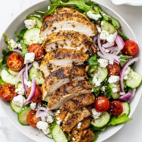 Golden brown pan-seared chicken salad, the juicy chicken slices over fresh greens, drizzled with vinaigrette.