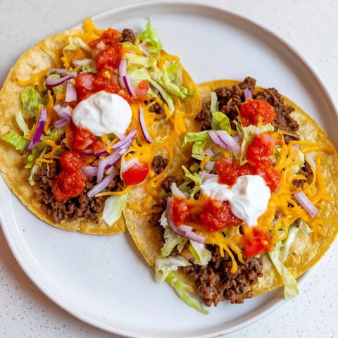 Golden brown Crispy Smash Tacos, with melted cheese and fresh toppings, ready to enjoy.