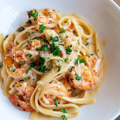 Creamy Garlic Shrimp Pasta features succulent shrimp coated in a luscious garlic cream sauce, served over al dente linguine and garnished with fresh parsley.
