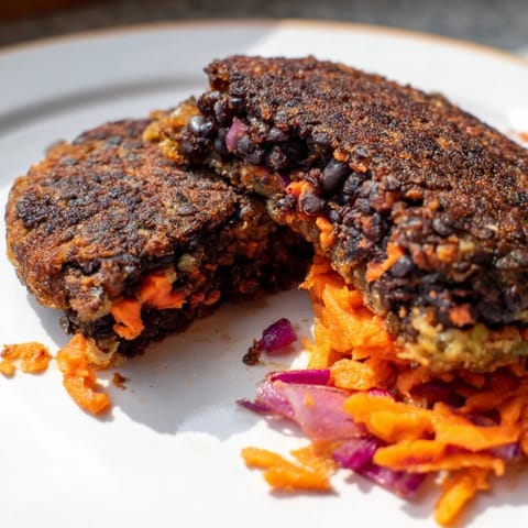 A close-up of a flavorful black bean burger, showing the tender, textured patty inside.