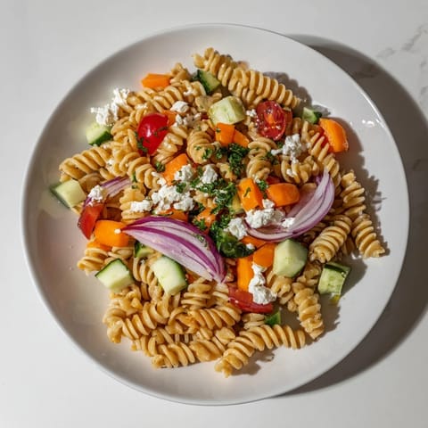 Freshly tossed pasta salad with seasonal veggies, a colorful, enticing and healthy meal.
