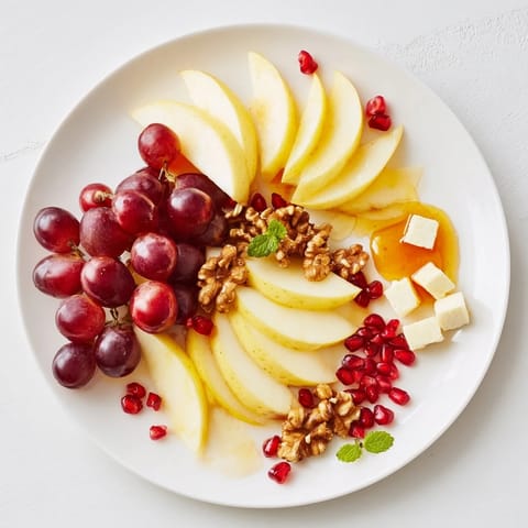 A beautiful Apple Orchard Fruit Board displays fresh fruit, honey, and nuts, perfect for sharing.