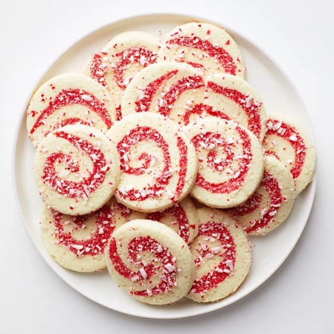 A beautifully arranged Candy Cane Swirl Cookie assortment, perfect for Christmas, offering a festive and sweet treat.