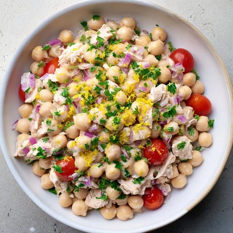 A close-up of a vibrant bowl of Dense Chickpea and Tuna Salad, ready to be enjoyed.