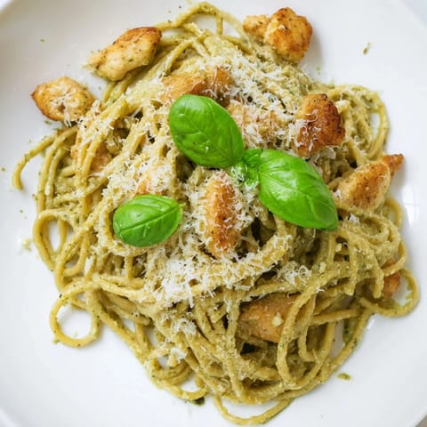 Golden chicken strips nestled in creamy pesto egg sauce over the delicious pesto egg and chicken pasta.