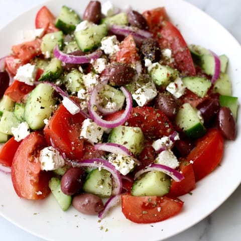 Fresh Mediterranean Salad with colorful vegetables, perfect for a light lunch, drizzled with olive oil.