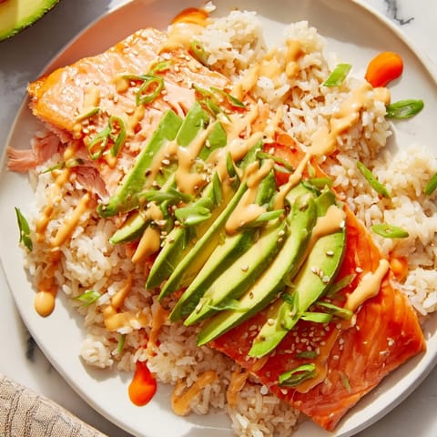 Visualize the creamy Japanese mayo drizzled over steaming Classic Salmon Rice with avocado slices.