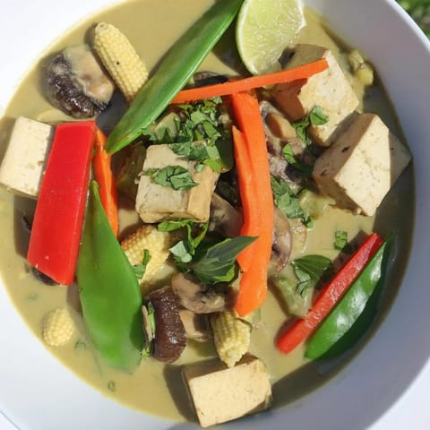 Aromatic Thai Green Curry Coconut Soup featuring colorful vegetables and creamy coconut milk ready to serve.
