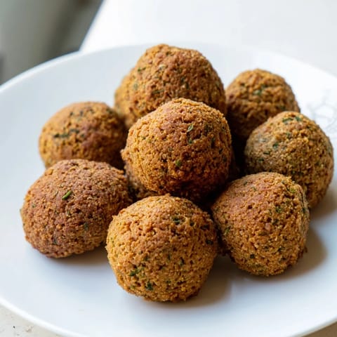 These hot and savory Levantine falafel balls, fried to perfection, are best served in a pita.