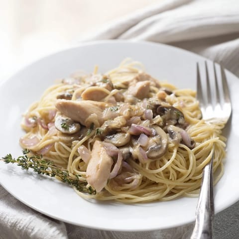 Creamy Mushroom Chicken Spaghettini features tender chicken strips and al dente pasta coated in a velvety mushroom Parmesan sauce.