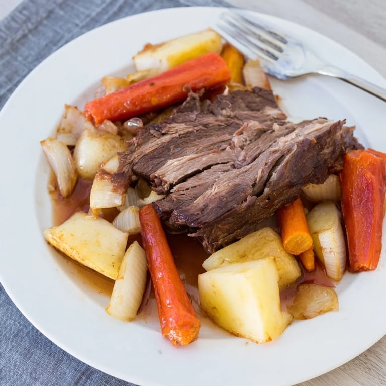 A hearty plate of Sunday pot roast with tender beef and beautifully roasted vegetables ready to serve.