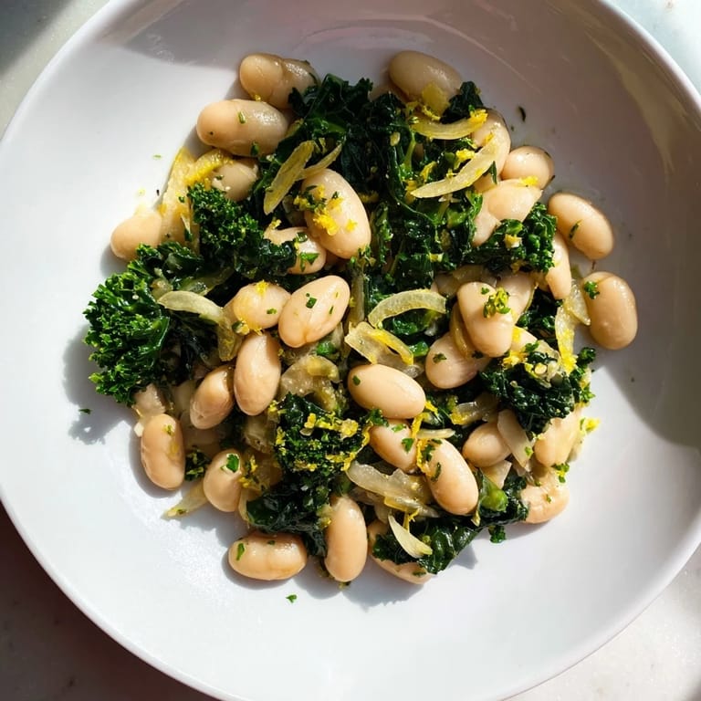 Close-up of vibrant Garlicky Beans with Winter Greens, showcasing tender greens and creamy beans, seasoned perfectly.