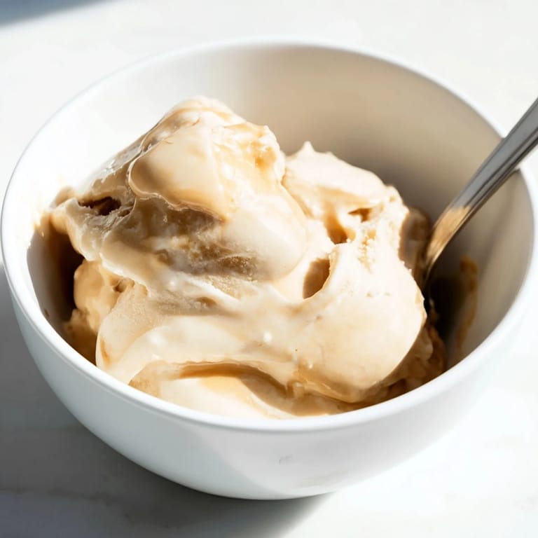 Homemade Peanut Butter Banana Ice Cream, perfectly blended with hints of vanilla, served in a dish.
