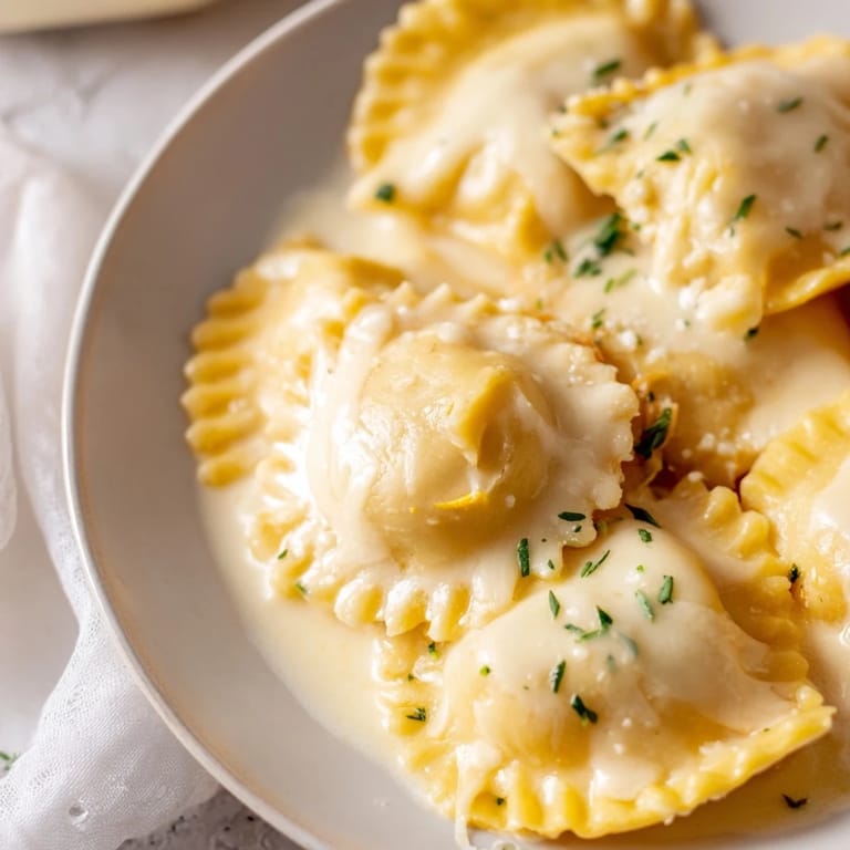 Creamy chicken with veggies nestled in ravioli, a comforting Chicken Pot Pie Ravioli Bake.