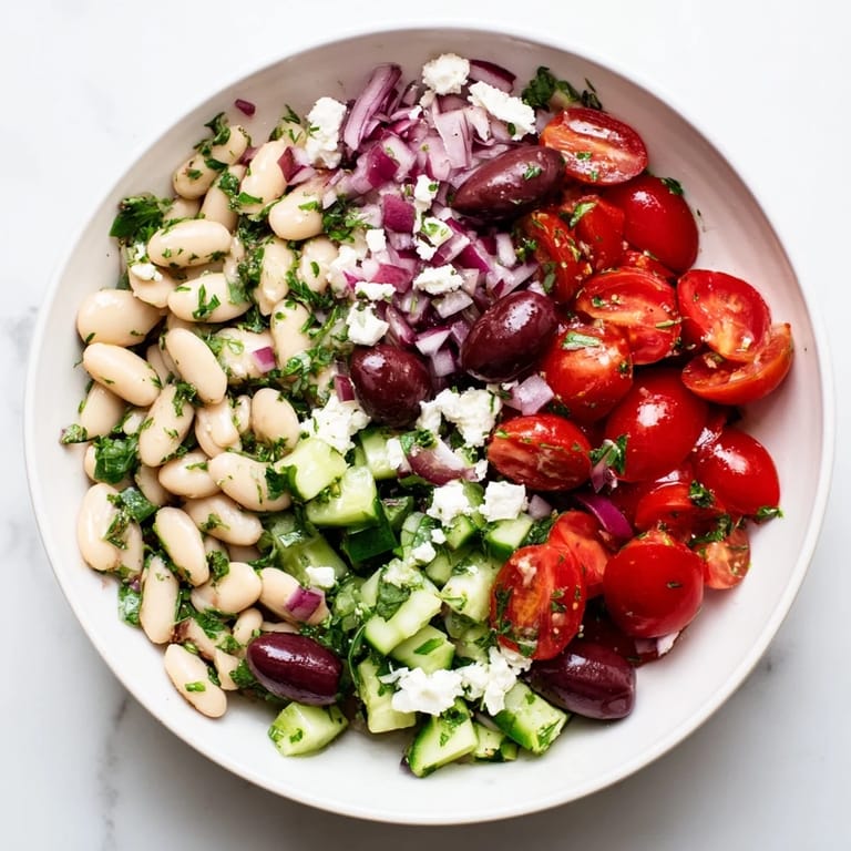 This appetizing white bean salad showcases creamy beans tossed with vibrant vegetables and tangy dressing.