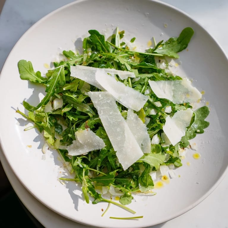 Vibrant arugula salad with lemon dressing, ready to enjoy with a burst of peppery flavor.