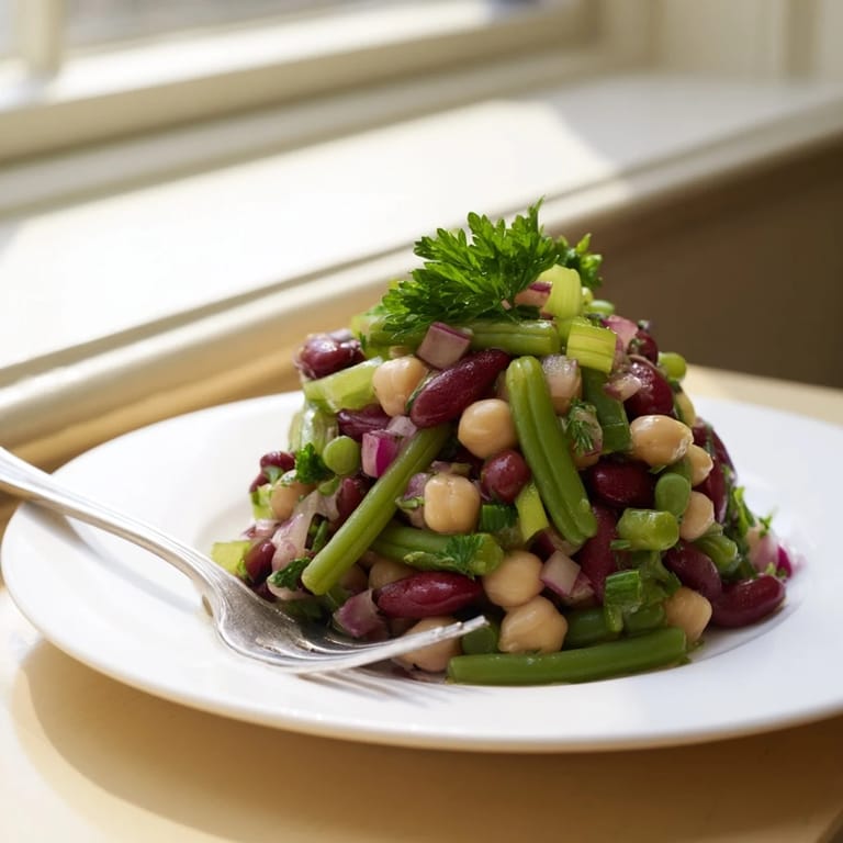 Freshly prepared Three-Bean Salad with a medley of beans, diced red onion, and herbs, perfect for a healthy picnic side dish.