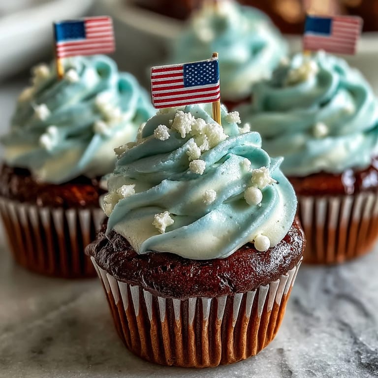These Star-Spangled Banner Cupcakes are topped with cheerful edible flags for a celebratory treat.