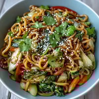 A vibrant Shirataki Noodle Bowl features crisp vegetables and toasted sesame seeds ready to serve.