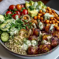 Vibrant lemon vinaigrette grain bowls with roasted chickpeas, fresh vegetables, and creamy avocado slices.